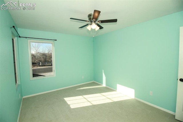 unfurnished room featuring ceiling fan and light carpet