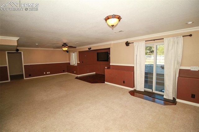 interior space with ceiling fan, ornamental molding, and a textured ceiling