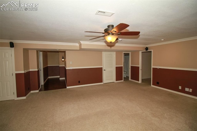 carpeted empty room featuring ornamental molding and ceiling fan