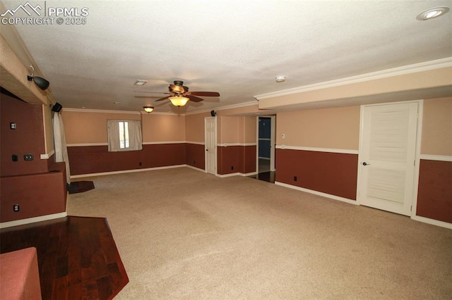 interior space featuring ornamental molding, carpet floors, ceiling fan, and a textured ceiling