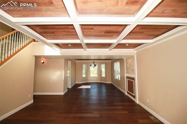 interior space featuring crown molding, coffered ceiling, and dark hardwood / wood-style flooring