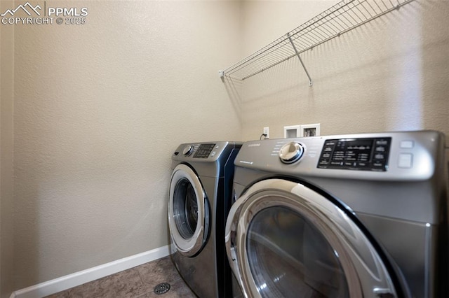 laundry room featuring tile patterned flooring and washing machine and dryer