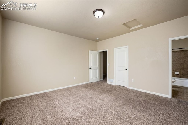 unfurnished bedroom featuring connected bathroom and carpet