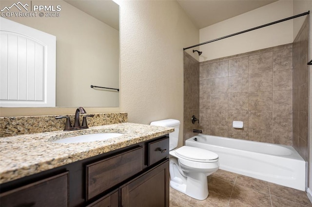 full bathroom featuring vanity, tile patterned floors, toilet, and tiled shower / bath