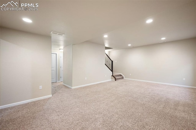 basement featuring light carpet