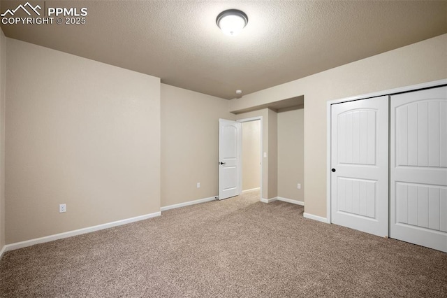 unfurnished bedroom with a closet, a textured ceiling, and carpet flooring