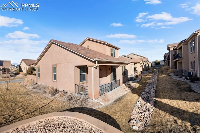 back of property featuring cooling unit