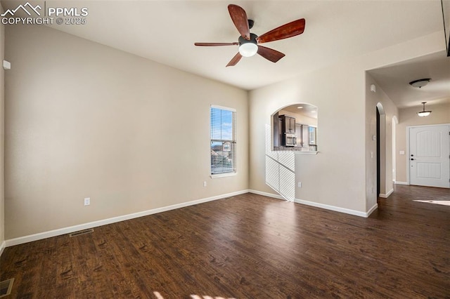 unfurnished living room with ceiling fan and dark hardwood / wood-style floors