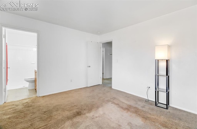 interior space featuring carpet and baseboards