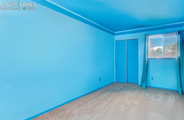 unfurnished bedroom featuring a closet and carpet flooring