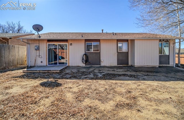 rear view of house with fence