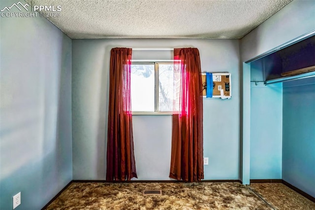 unfurnished bedroom with a closet, a textured ceiling, and carpet flooring