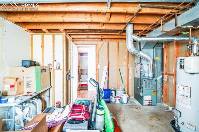 basement featuring heating unit and water heater