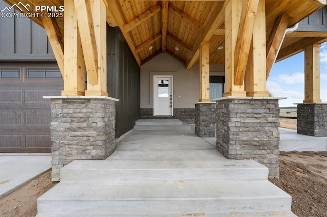 entrance to property with stone siding and covered porch