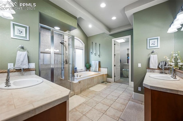 bathroom with tile patterned floors, vanity, independent shower and bath, and vaulted ceiling