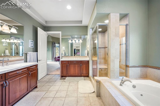 bathroom featuring tile patterned floors, vanity, and shower with separate bathtub