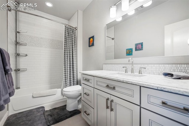 full bathroom featuring vanity, shower / tub combo, and toilet