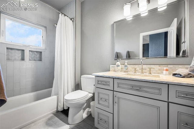 full bathroom with tasteful backsplash, vanity, toilet, and shower / bath combo with shower curtain