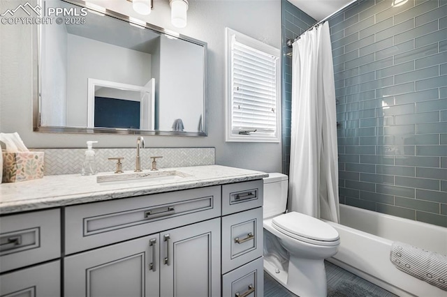 full bathroom featuring vanity, toilet, and shower / bath combo with shower curtain