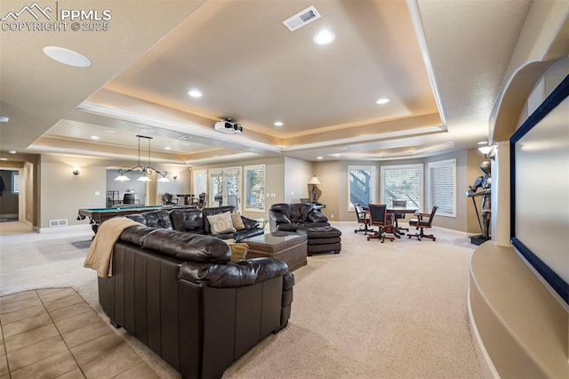 carpeted living room with billiards and a tray ceiling