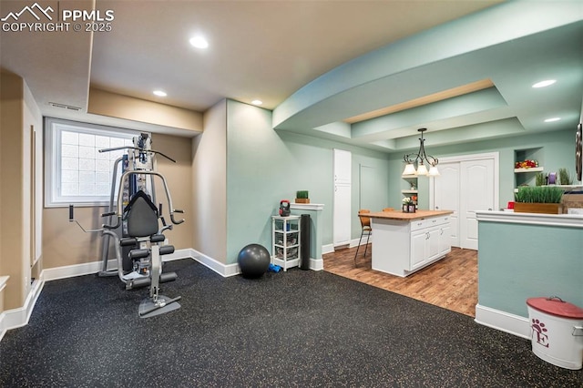 exercise area with a tray ceiling