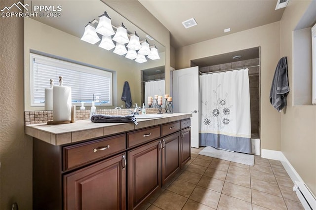 bathroom with baseboard heating, shower / bath combination with curtain, vanity, and tile patterned flooring