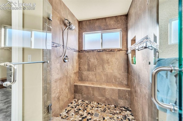 bathroom with a shower with door