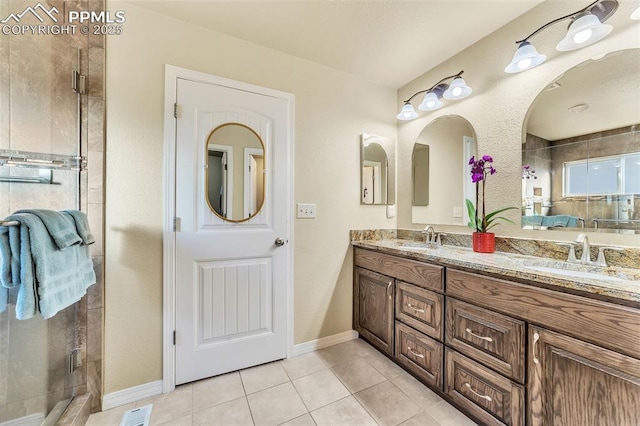 bathroom featuring tile patterned floors, vanity, and a shower with shower door