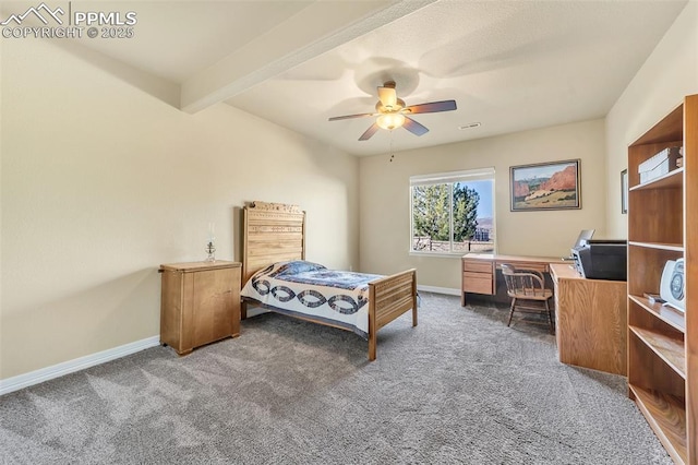 carpeted bedroom featuring beam ceiling and ceiling fan