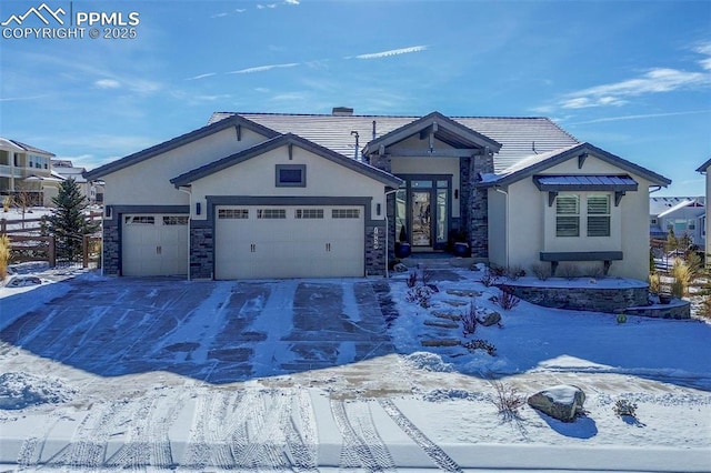 view of front of home with an attached garage, stone siding, driveway, and stucco siding