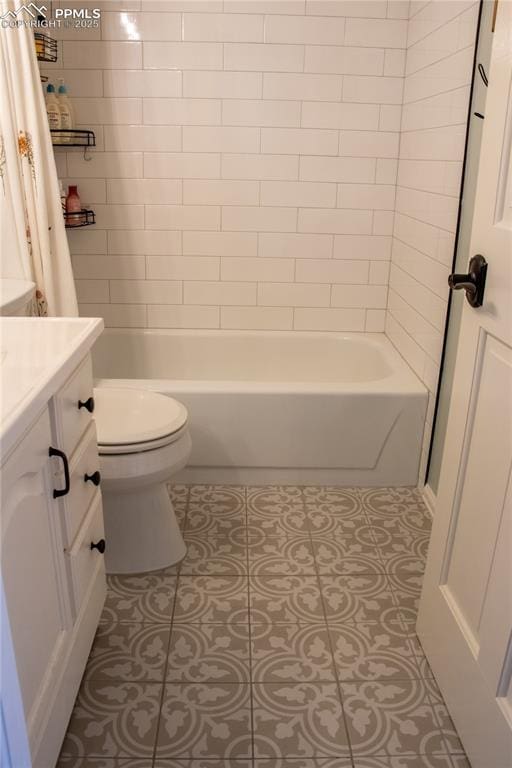 full bathroom featuring shower / bath combination with curtain, tile patterned floors, toilet, and vanity