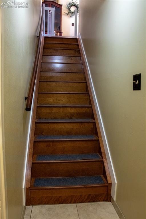 staircase with tile patterned floors