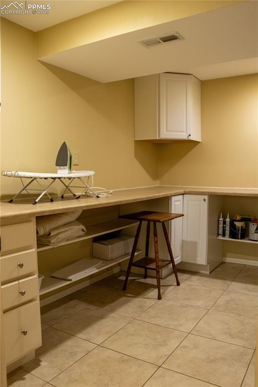 kitchen with white cabinetry and light tile patterned floors