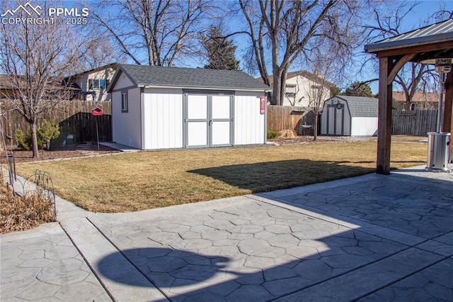 view of yard with a storage shed and a patio area