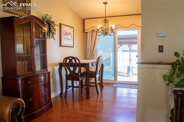 dining room with wood-type flooring and a notable chandelier