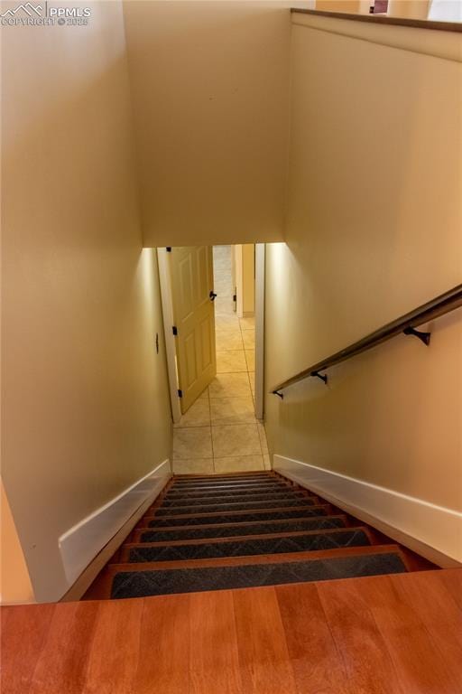 stairway featuring wood-type flooring