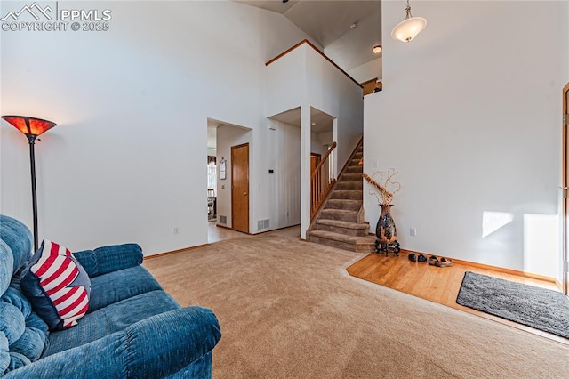 carpeted living room featuring a high ceiling