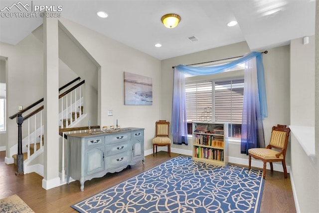 sitting room with recessed lighting, baseboards, wood finished floors, and stairs