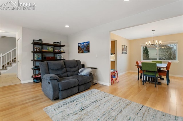 living room with stairway, wood finished floors, baseboards, recessed lighting, and a chandelier