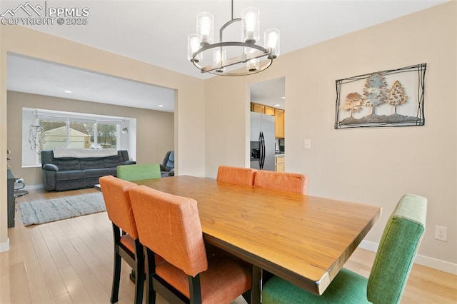 dining room featuring a chandelier and light wood-type flooring