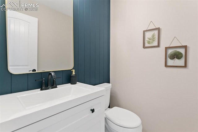 bathroom featuring vanity and toilet