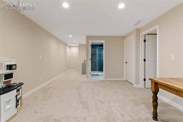 interior space featuring visible vents, recessed lighting, light colored carpet, and baseboards