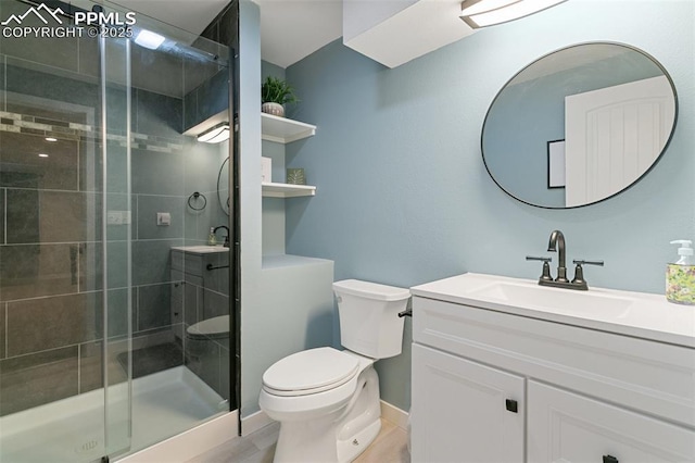 bathroom featuring walk in shower, vanity, and toilet