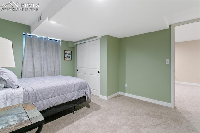 bedroom featuring light colored carpet and a closet