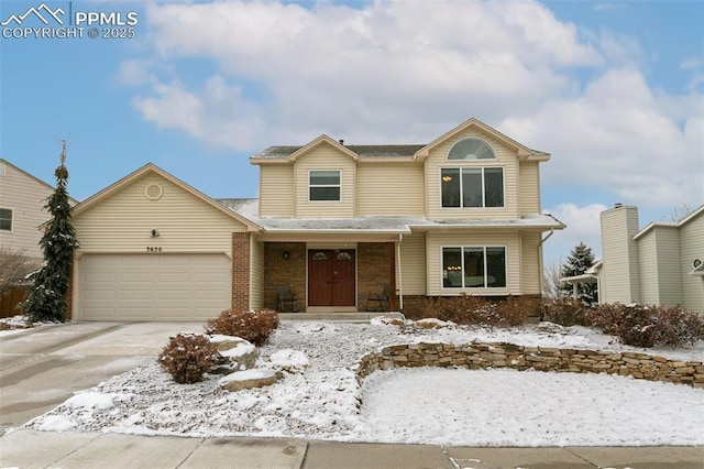 view of front of house with concrete driveway, an attached garage, and brick siding