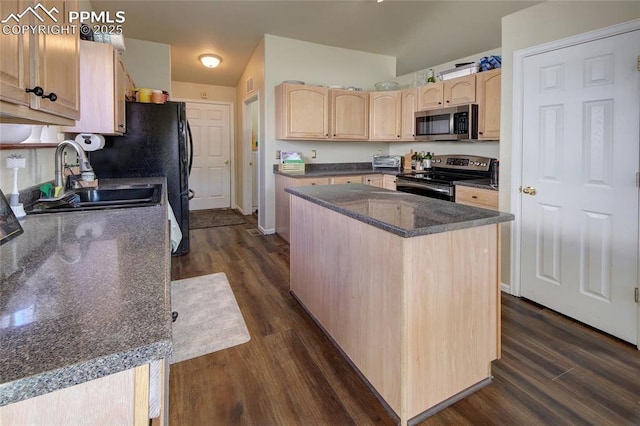 kitchen featuring dark wood-style floors, a kitchen island, stainless steel appliances, light brown cabinetry, and a sink