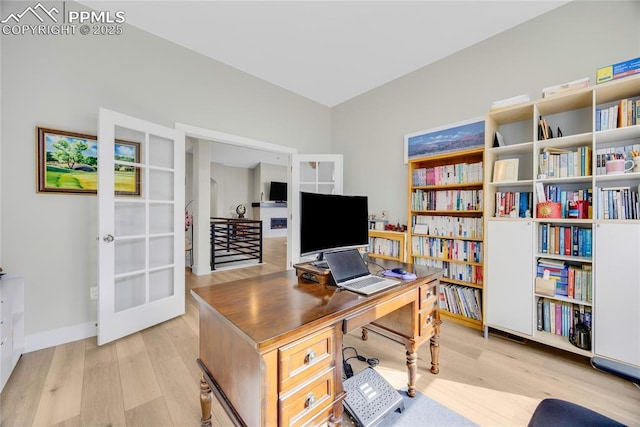 office featuring french doors and light hardwood / wood-style flooring