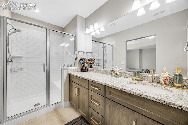 bathroom featuring vanity, an enclosed shower, and tile patterned flooring