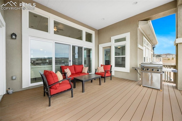 wooden terrace with outdoor lounge area and grilling area