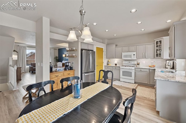 dining area featuring sink and light hardwood / wood-style flooring